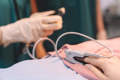 Analysing a person's oxygen levels, pulse and temperature can help detect Covid-19 cases. Getty