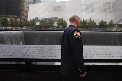 A New York City firefighter looks for the names of colleagues killed on September 11, 2001 at the 9/11 Memorial. Getty Images