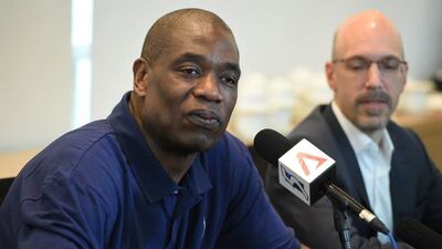 Congolese American retired professional basketball player Dikembe Mutombo (L) anwers questions as Scott Levy (R) Managing Director for NBA Asia listens during a media roundtable interview in Singapore on April 5, 2016. Mutombo, an eight-time NBA All-Star and four-time NBA Defensive Player of the Year is in Singapore for the second meeting of the Jr. NBA Asia Advisory Council. AFP / ROSLAN RAHMAN