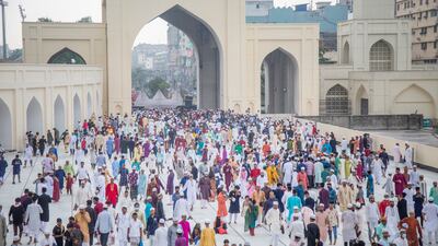 People arrive for Eid Al Fitr prayers at the Baitul Mukarram National Mosque in Dhaka, Bangladesh. EPA