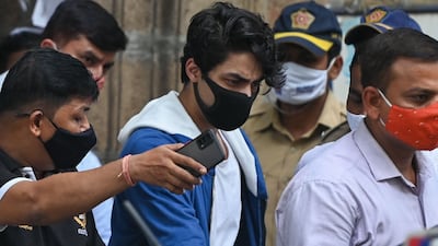 Aryan Khan, centre, the son of Bollywood actor Shah Rukh Khan, is escorted to court by Narcotics Control Bureau officials for a bail plea hearing in Mumbai on October 8, 2021. AFP