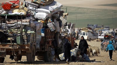 Displaced Syrians gather at a makeshift camp for those fleeing the northern Syrian town of Manbij on March 8, 2017, seeking safety in territory held by a Kurdish-Arab alliance called the Syrian Democratic Forces. Delil Souleiman/AFP