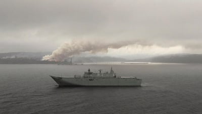 HMAS Adelaide operates off the coast of Eden, Australia, as fires burn during Operation Bushfire Assist. Reuters