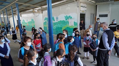 Girls wait to enter their classrooms on the first day of school in a Yazidi displaced persons camp near Dohuk in Iraqi Kurdistan. AFP