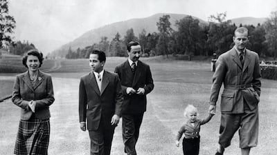 King Faisal II walks alongside Queen Elizabeth II, the Duke of Edinburgh, and Princess Anne at Balmoral Castle in 1952. Getty Images