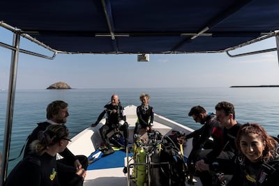 Fernando Reis from Shark Educational Institute and a team of divers approach Dibba Rock. Antonie Robertson / The National