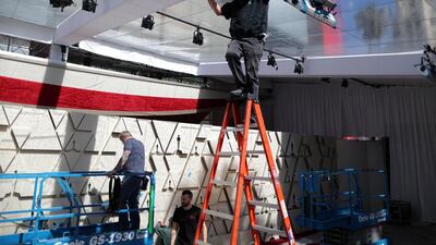 Workers construct a red carpet backdrop. Reuters