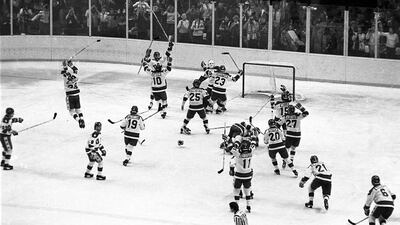 1980 Winter Olympic Games: In this Feb. 22, 1980 file photo, the U.S ice hockey team rushes toward goalie Jim Craig after their upset win over the Soviet Union in the final group stage of the Winter Olympic Games in Lake Placid, N.Y. (AP Photo, File)