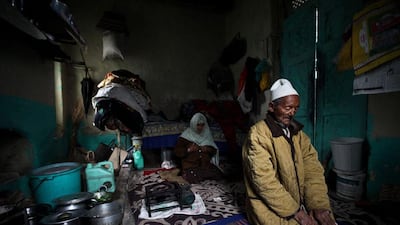 A couple, both leper patients, pray in their room.