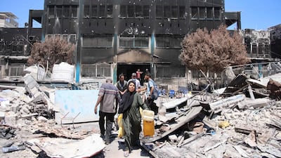 Palestinians salvage belongings from a damaged UN-run school in the Jabalia refugee camp in northern Gaza. AFP