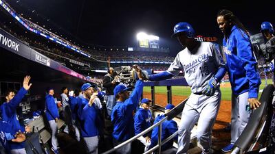 Salvador Perez #13 of the Kansas City Royals celebrates with teammates in the dugout in the ninth inning against the New York Mets during Game Five of the 2015 World Series at Citi Field on November 1, 2015 in the Flushing neighborhood of the Queens borough of New York City. Al Bello/Getty Images/AFP