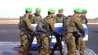 Israeli soldiers carry the coffins of deceased hostages after their bodies were handed over as part of the ceasefire deal. Reuters