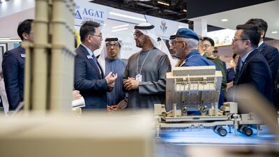 Sheikh Mohamed and Sheikh Mansour visit a booth at the event