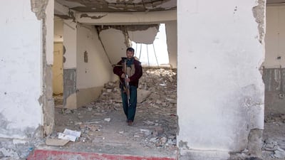 Soldiers keep watch in Afghanistan's Helmand. The building, formerly the office of the governmor of Nawa-i-Barakzay district, has been bombed and attacked by the Taliban, leaving ruins and bullet-riddled walls. Photo by Stefanie Glinski