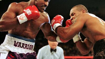 Evander Holyfield lands a punch on Mike Tyson in the first round of their second fight in June 1997. Reuters