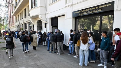 People wait in a long queue to enter the Moroccan consulate general in Bilbao. AFP