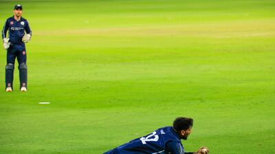 Hamza Tahir makes a diving catch for Scotland against Oman. Photo: ICC