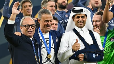 Luis Campos, left, sporting director of Paris Saint Germain, Luis Enrique, centre, head coach, and Nasser Al-Khelaifi, club president, celebrate the Intercontinental Cup win. EPA