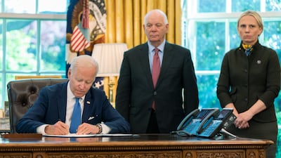 US President Joe Biden signs the Ukraine Democracy Defence Lend-Lease Act in the Oval Office of the White House in May 2022, with Mr Cardin and Ukraine-born House member Victoria Spartz. AP