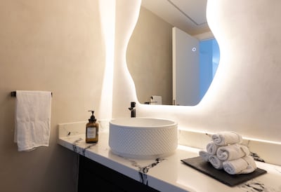 The downstairs bathroom uses micro-cement on the floors and walls. Chris Whiteoak / The National