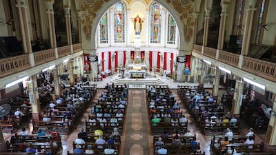 People offer prayers at St Peter's Church in Mumbai to mark the one-month anniversary of the Air India flight that crashed in Ahmedabad. EPA