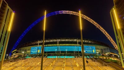 Wembley Stadium's arch lit in yellow and blue in solidarity with Ukraine after Russia's invasion in February 2022. PA