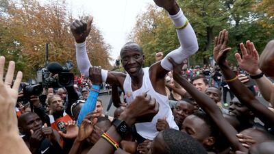 Marathon runner Eliud Kipchoge from Kenya is celebrated after crossing the finish line of the INEOS 1:59 Challenge after 1:59:40 in Vienna, Austria. He is the first man ever to run a marathon under two hours. AP Photo