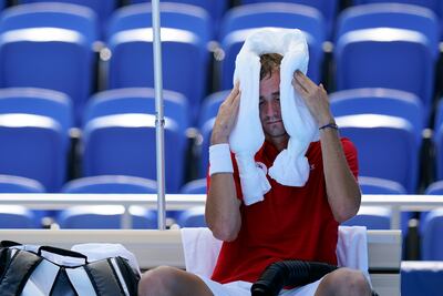 Daniil Medvedev cools down with an ice towel during his match against Alexander Bublik, of Kazakhstan at the Olympics.