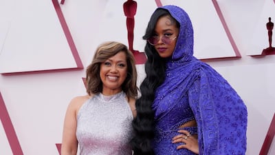 Agnes Wilson, left, and H.E.R. arrive to the Oscars red carpet for the 93rd Academy Awards in Los Angeles, California, US, April 25, 2021. AP Photo