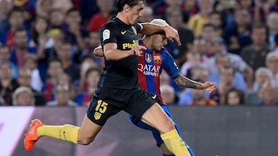 Atletico Madrid’s Stefan Savic, left, vies with Barcelona’s Neymar. Josep Lago / AFP