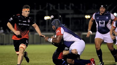 Jebel Ali Dragons, white, and Dubai Exiles, black, in action.