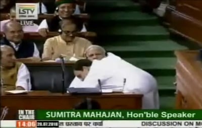 A video grab provided by Lok Sabha Television, a government-owned parliament channel, shows Congress party President Rahul Gandhi hugging Indian Prime Minister Narendra Modi. Lok Sabha Television via AP