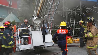 Firemen rescue trapped employees during a fire at the Manila Pavilion Hotel and Casino on Sunday, March 18, 2018. Bullit Marquez / AP Photo