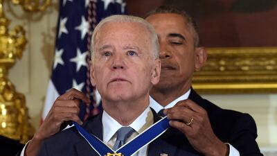 Mr Biden receives his Presidential Medal of Freedom in 2017. AP