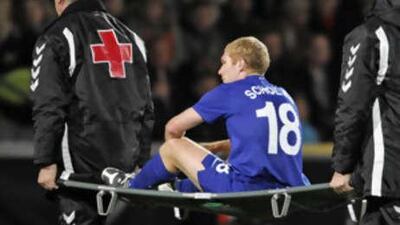 Manchester United's Paul Scholes is stretchered off after injuring his medial ligaments in his right knee against Aalborg in Denmark.
