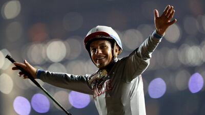 Victor Espinoza, who competed with California Chrome from USA, celebrates after winning the ninth and final race. REUTERS/Ahmed Jadallah
