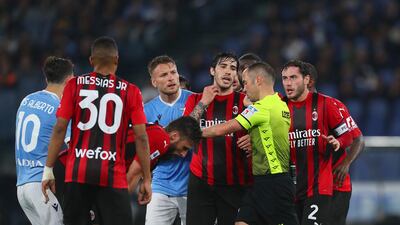 Davide Calabria and Sandro Tonali of AC Milan and Ciro Immobile of Lazio confront referee Marco Guida. Getty Images