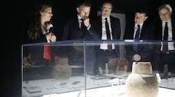 French President Emmanuel Macron, second from left, with Lebanon’s ambassador to France Rabih Chaer, centre, and curator Tania Zaven, far left, at Arab World Institute in Paris. AFP