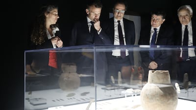 French President Emmanuel Macron, second from left, with Lebanon’s ambassador to France Rabih Chaer, centre, and curator Tania Zaven, far left, at Arab World Institute in Paris. AFP