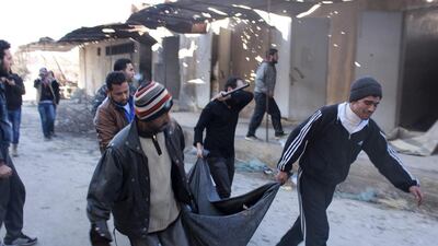 Men carry a body, believed to be one of the detainees held and executed by fighters from the Islamic State in Iraq and the Levant (Isil), after it was discovered in a hospital in Aleppo that had been an Isil stronghold before it was captured by rival rebel forces on January 8. Five days of heavy rebel infighting has shaken the Al Qaeda-linked faction, which lost its main base in the northern city of Aleppo to rival rebels, according to a monitoring group. Abdalrhman Ismail/Reuters