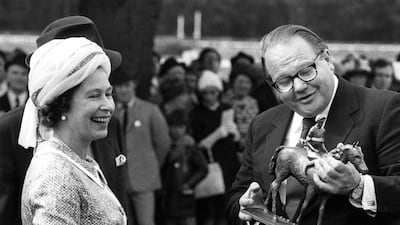 Nelson Bunker Hunt, seen here receiving the winners trophy from Queen ELizabeth, owned hundreds of race horses. Central Press / Getty Images