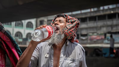 A man drinks water during a heatwave in Dhaka as temperatures soar across the country. EPA