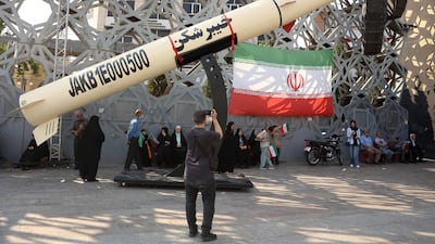 Iranians stand next to a model of a Kheibar missile at a rally in support of supreme leader Mojtaba Khamenei on Thursday. AFP