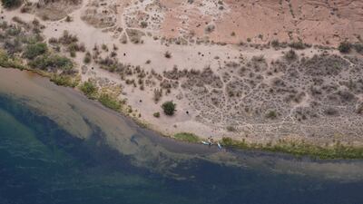 Kayakers rest on the dry shore of the Colorado River in Horseshoe Bend.