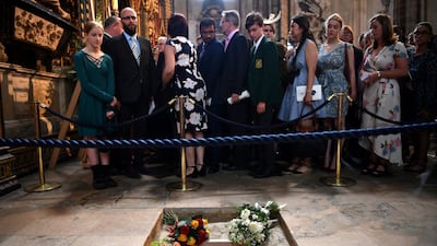Members of the congregation file past the ashes of British scientist Stephen Hawking at the site of their interment in the nave of the Abbey church, during a memorial service at Westminster Abbey in London on June 15, 2018. Ben Stansall / Pool via Reuters
