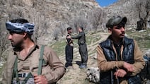 Two members of a Kurdish Iranian dissident group say goodbye to each other on Thursday near their military bases hidden among the mountains in Khalifa in Iraq's Erbil province. Getty Images