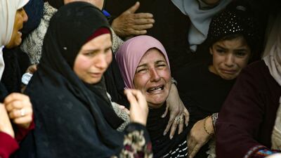The mother (C) of Badr Nafla, 19, who died after reportedly being shot by Israeli forces in the neck in the midst of confrontations near the northern West Bank city of Tulkarem yesterday, reacts during his funeral in the same city. AFP