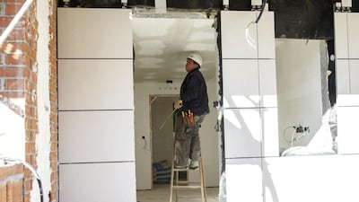 A worker stands on a ladder at a construction site of a residential block in the Valdebebas neighbourhood. Spanish construction accounts for 5 per cent of the country’s output compared to 10 per cent in the boom years, or an annual shortfall of about 50 billion euros ($62 billion), and employs less than half than before the housing crash of 2008, with no quick prospect of a sharp rebound. Andrea Comas / Reuters
