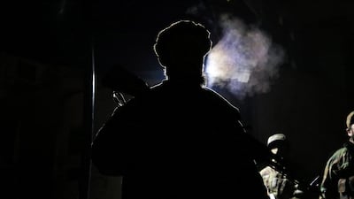 Taliban fighters stand guard at the scene of the bomb blast. EPA