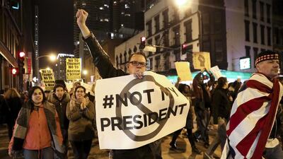 Protesters march North on State Street to express their disapproval of the election of Donald Trump as the 45th president of the United States. Armando Sanchez /Chicago Tribune via AP